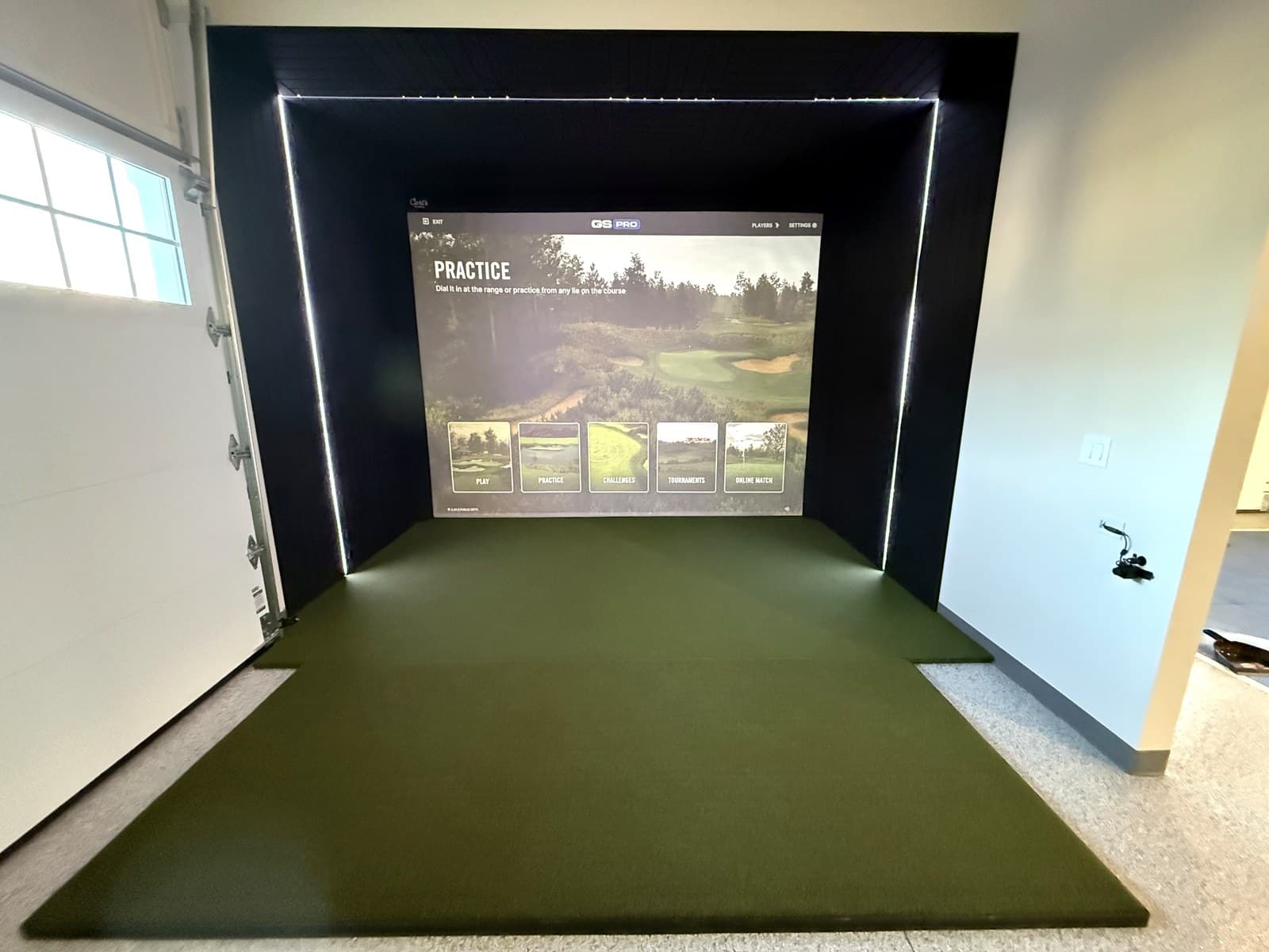 Garage · Dorn Custom Homes golf simulator in Allouez · 2026 Brown County Showcase of Homes